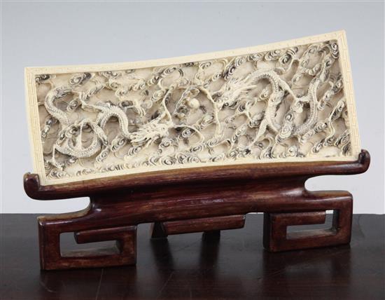 A Chinese ivory dragon plaque, early 20th century, 25cm., wood stand